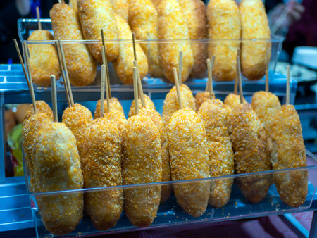 Homemade fried breaded Corn Dogs in a plastic containerの写真素材