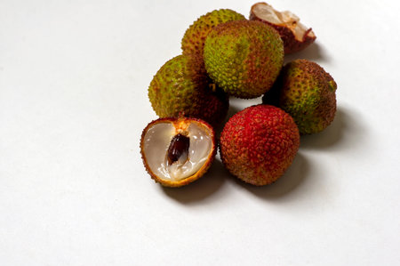 Fresh ripe litchi, lichee, lychee, or Litchi chinensis, shallow focus with white background