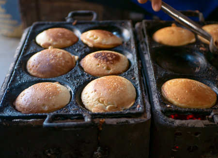 The process of cooking Kue Apem, an Indonesian traditional cake on street food market, in Yogyakarta, Indonesia.の写真素材