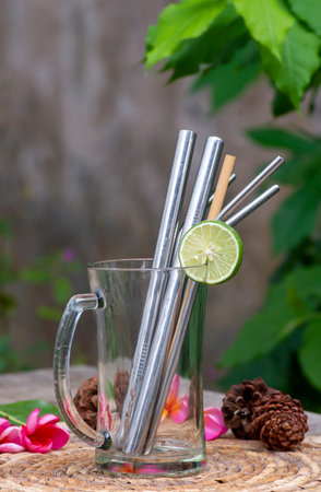 Bamboo and steel straws, an alternative to reducing plastic straws. The concept of reducing non-degradable plastic waste.の写真素材