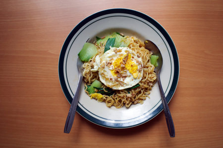 Mie Goreng Telor, Indonesian traditional street food, fried noodles with egg cooked with spices...