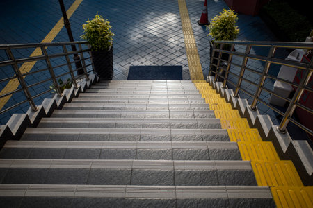 Stairway with Yellow Tactile Paving, textured walkway for blind people.