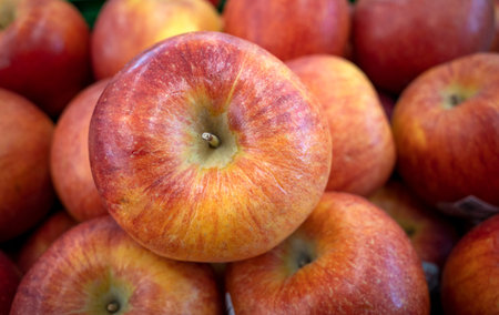 A pile of fresh ripe red apples in the supermarket.