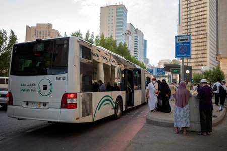 Mecca, Saudi Arabia - June 12, 2024: A public bus, a free transportation facilities in Makkah city, Saudi Arabia for Muslims pilgrims who perform hajj and umrah.のeditorial素材