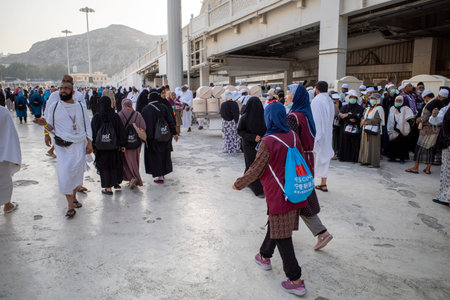 Mecca, Saudi Arabia - June 4, 2024: Hajj and Umrah pilgrim from China walking near Masjidil Haram, Great Mosque in Mecca, Saudi Arabia. Hajj 2024.のeditorial素材