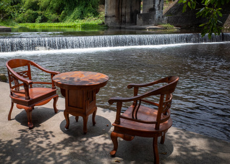 A chair set on the river bank to relax and enjoy food and drinks in the afternoon.の写真素材