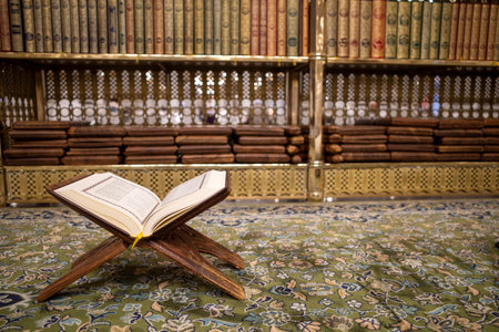 The holy book of the Quran is opened on a green carpet at the Prophet Mosque, Masjid Nabawi in the city of Medina, Saudi Arabia.の写真素材