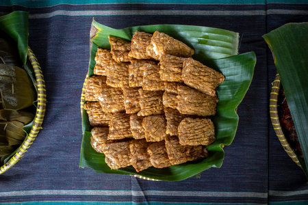 Close up of Tempe Garit Goreng (fried soybean cake) on banana leaf. Indonesian traditional food.の写真素材