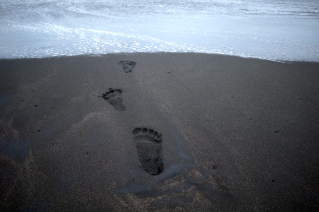 Foot prints on the sandy beach, in Depok Beach, Yogyakarta, Indonesia.