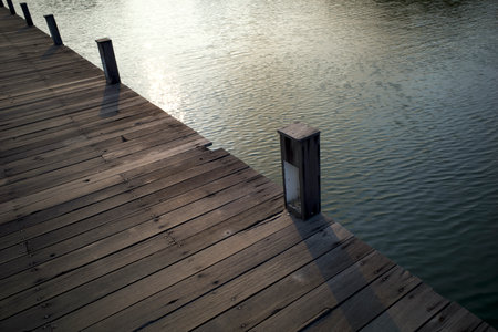 An old wooden bridge over an artificial lake in Semarang, Central Java, Indonesia.の写真素材