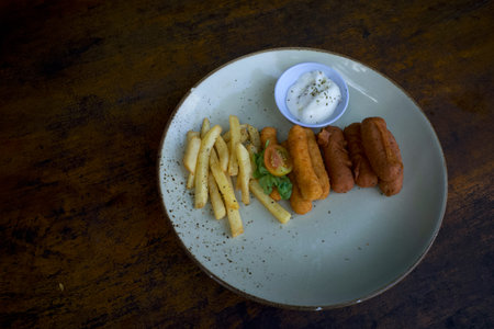 Mix Platter, food mix of various ingredients of food, french fries, sausage, sliced tomatoes on a...