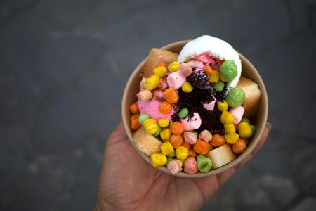 Snack Ice Cream, with colorful toppings in a paper bowl.の写真素材