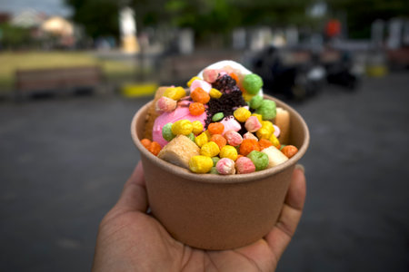 Snack Ice Cream, with colorful toppings in a paper bowl.の写真素材