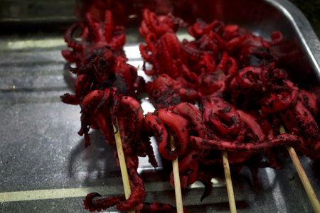 Red Octopus satay or squid satay with bamboo skewers, Indonesian street food.の写真素材