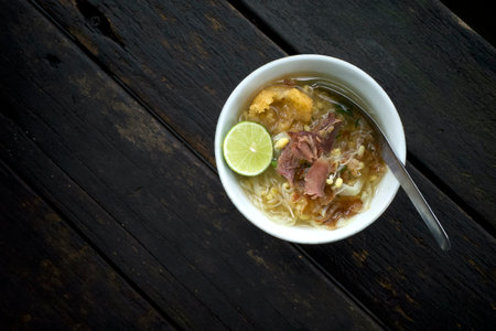 Soto Daging, a traditional Javanese, Indonesia beef soup with vegetables and rice.の写真素材