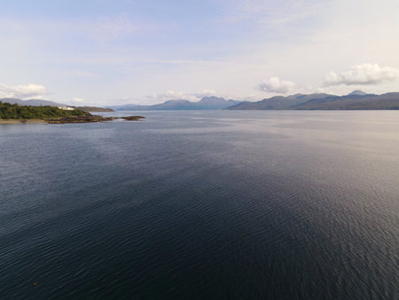 Remote scottish loch waters reflecting cloudy sky
