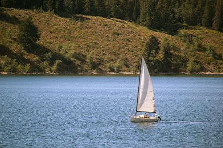 A sailboat on Jackson Lake Wyomingの写真素材