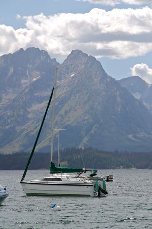 A sailboat on Jackson Lake under the Grand Tetonsの写真素材