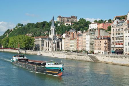 A boat on the river Saone running through the city of Lyon in Franceの写真素材