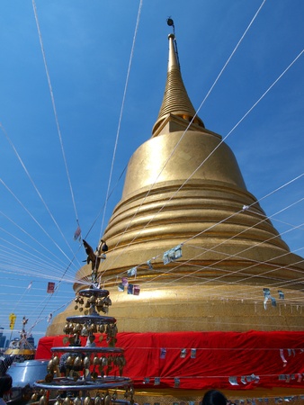 Golden Buddha Pagoda and traditional thai sculpture on blue sky       のeditorial素材