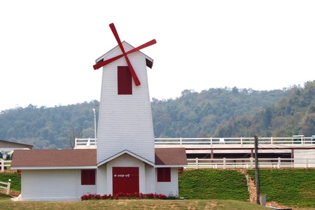 house with wind turbine and mountain backgroundのeditorial素材