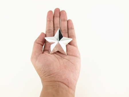 Silver star in hands on white background    の写真素材