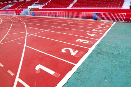 Lanes of a red race track with numbers and red seats in the stadiumのeditorial素材