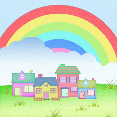 house from recycle paper with grass field rainbow backgroundの写真素材