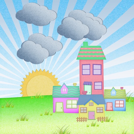 house from recycle paper with grass field and sun set backgroundの写真素材