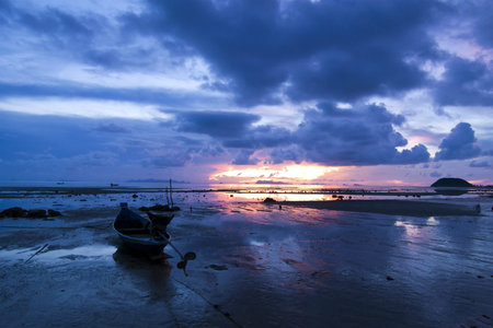 Boat on the beach at sunset time