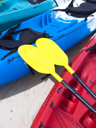 Yellow kayak oar on the red kayak の写真素材