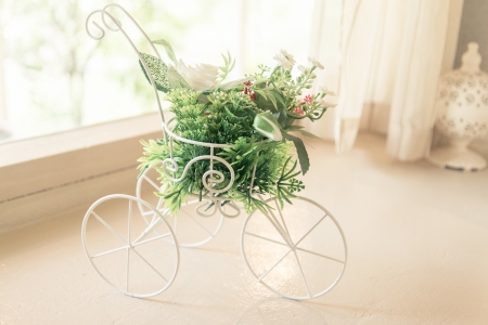 Vintage tone bicycle with artificial flower -  home interiorの写真素材