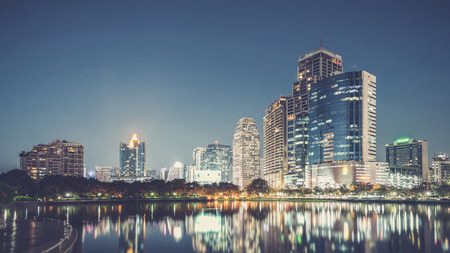 Bangkok city downtown at night with reflection of skyline, Bangkok,Thailand (Vintage filter effect used)の写真素材