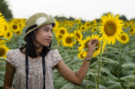 Girl in the sunflowers field with sunflowersのeditorial素材