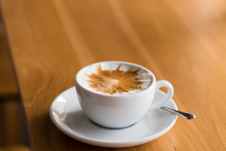 cup of coffee in a white cup on wooden background,coffee shopの写真素材