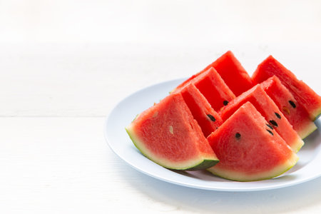 Watermelon cut into pieces on a white plate
