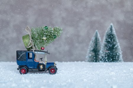 small retro car with Christmas tree on the roof, going on holidayの写真素材