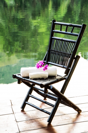 Towel set on the chair beside the riverの写真素材