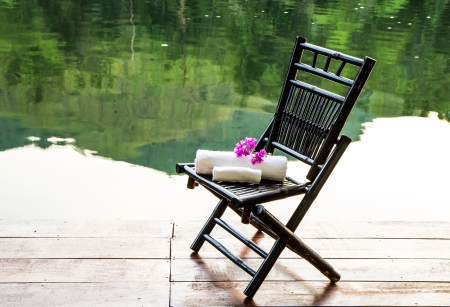 Towel set on the chair beside the riverの写真素材