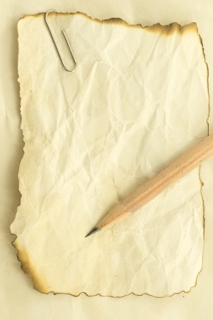 Frame with old paper and a pencil burns for Notebook の写真素材