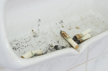 many cigarette butts close up in ash receiverの写真素材