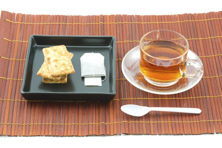 Cup of yellow tea with dry tea leaves on  woven wood の写真素材