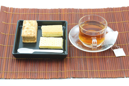Cup of yellow tea with dry tea leaves on  woven wood の写真素材