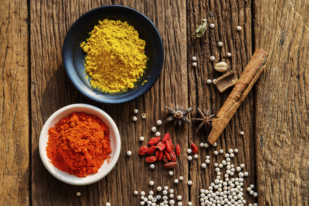 Powder spices on cup  in  on  old wooden table の写真素材