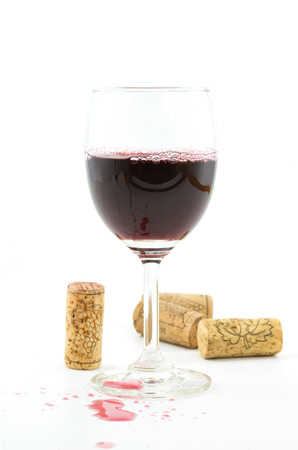  vintage wine corks,red wine in wineglass on white background.の写真素材