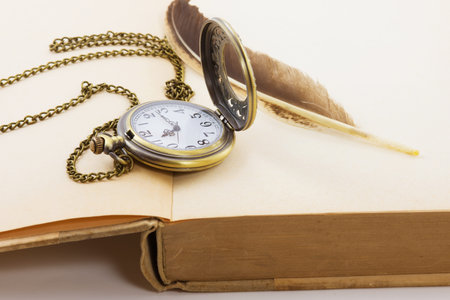 Vintage grunge still life with antique pocket watch, and old book  ,quill  の写真素材