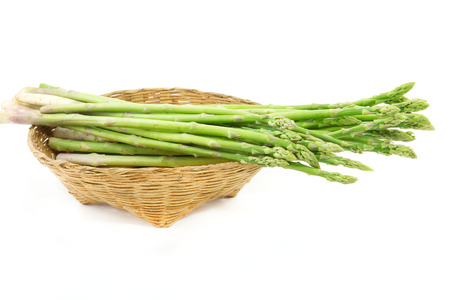 asparagus in basket  isolated on a white backgroundの写真素材