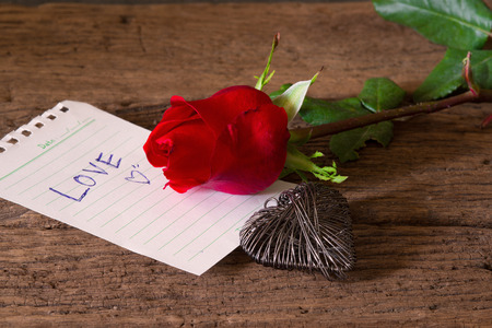 Red roses on wood and paper of love,heartの写真素材
