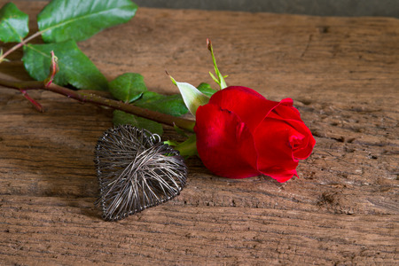 Red roses on wood and heartの写真素材