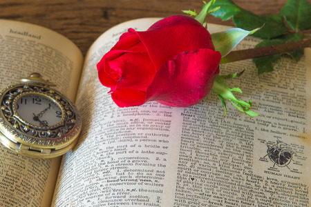 Red rose on book and antique clock concept of love ,valentine's dayの写真素材